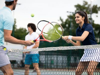 Fit happy poeple playing tennis together. Sport concept