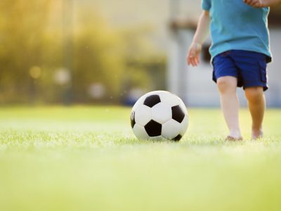 Little boy playing football