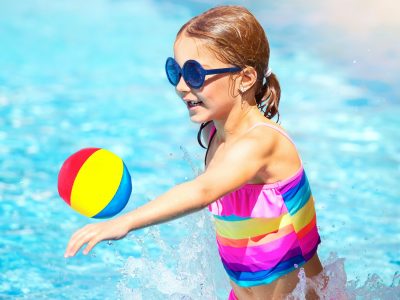 Little girl playing in the pool