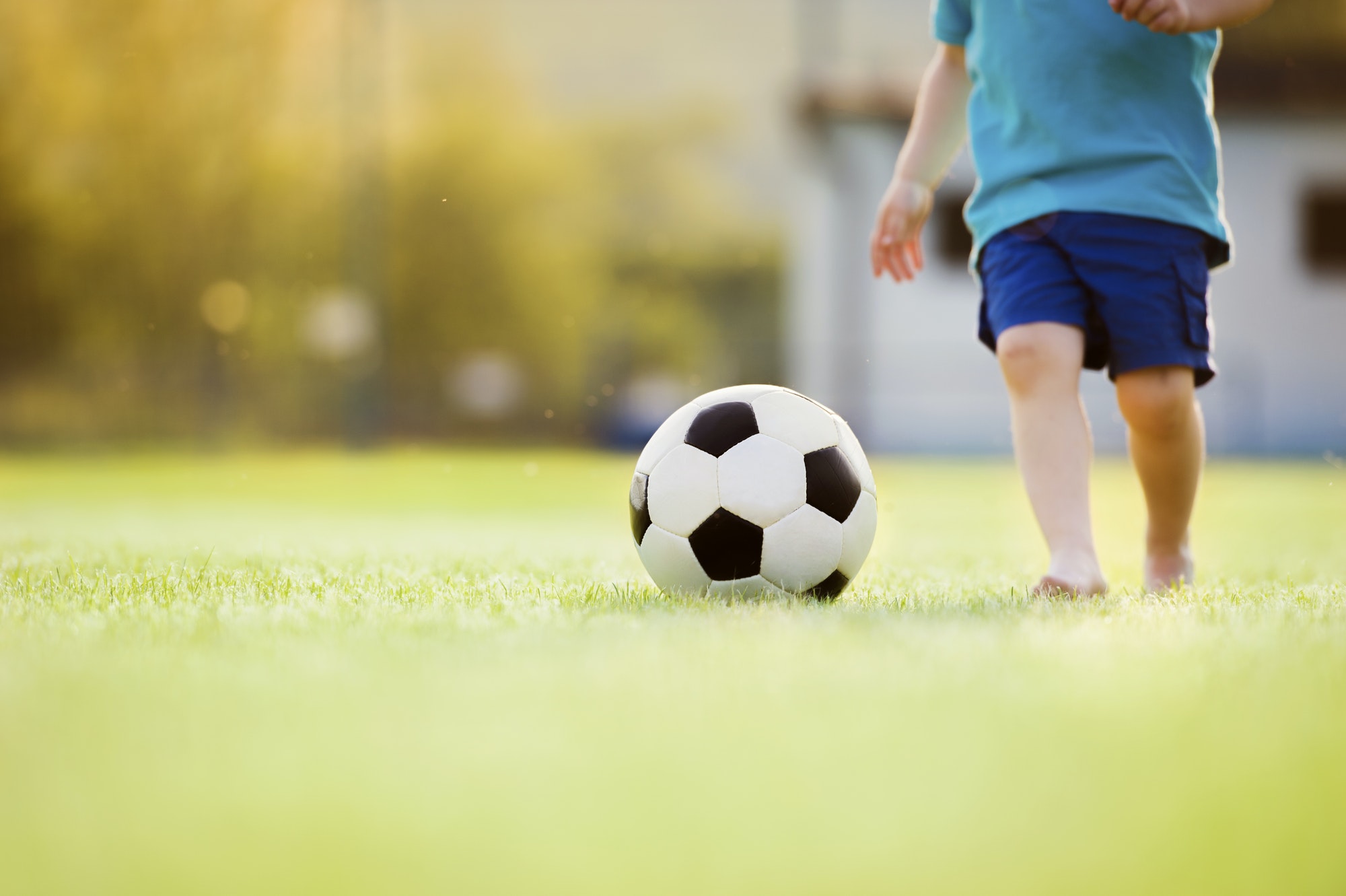 Little boy playing football