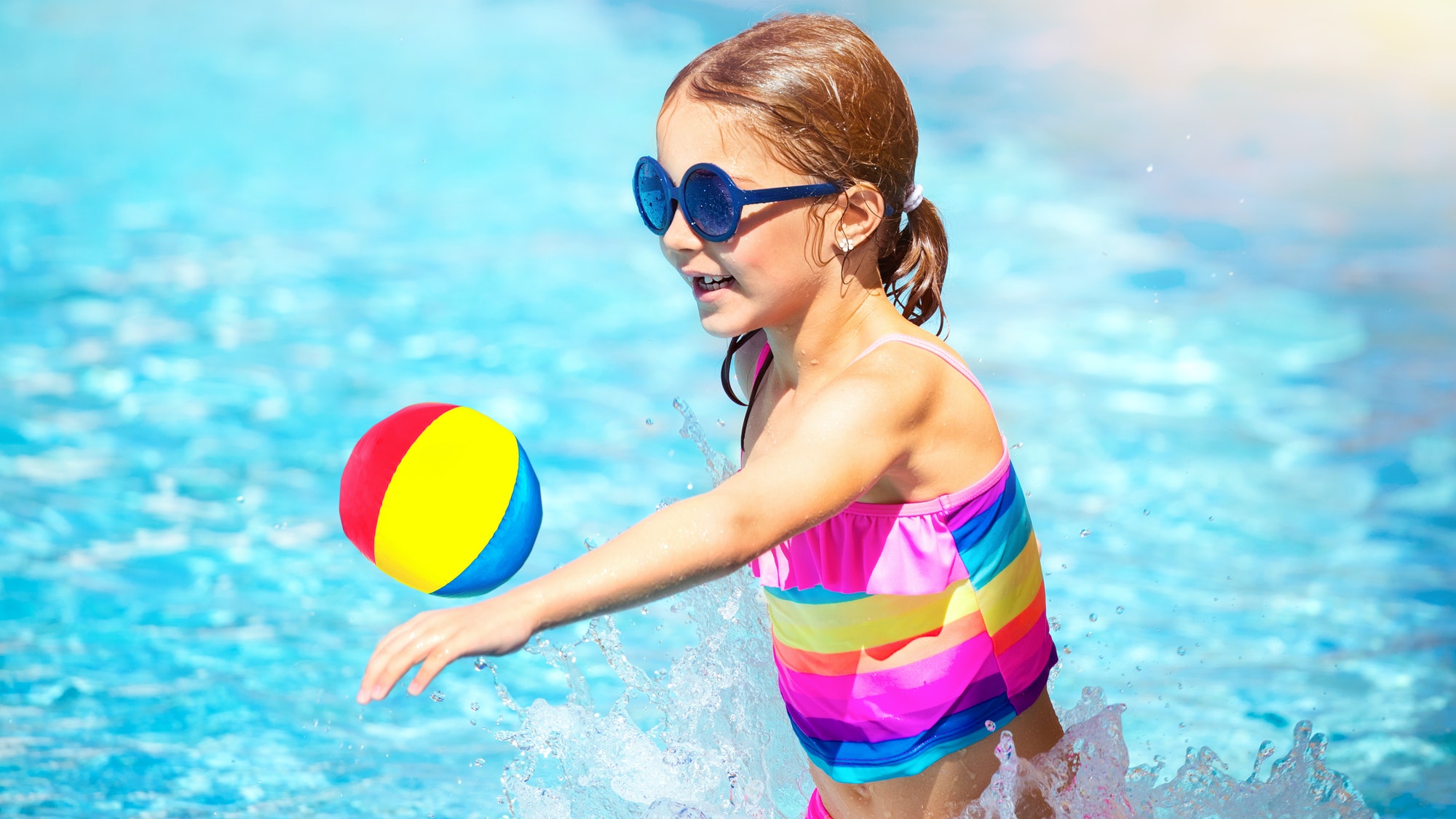 Little girl playing in the pool